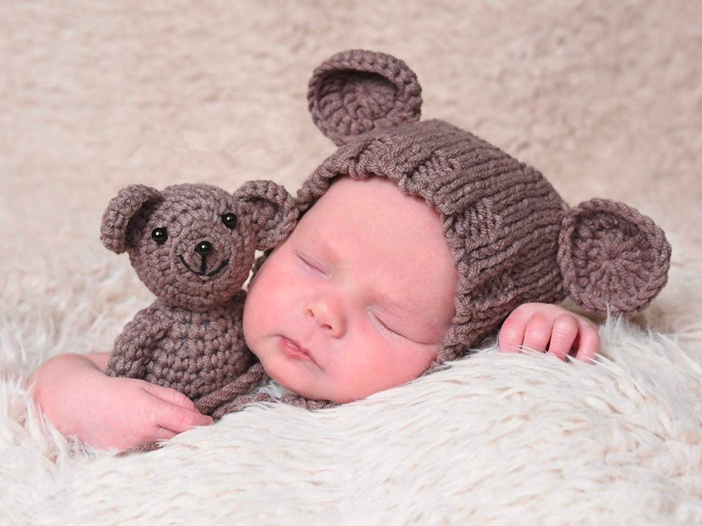 Newborn baby boy wearing the brown hand knitted crochet newborn teddy bear hat with matching teddy for reborn dolls and babies.