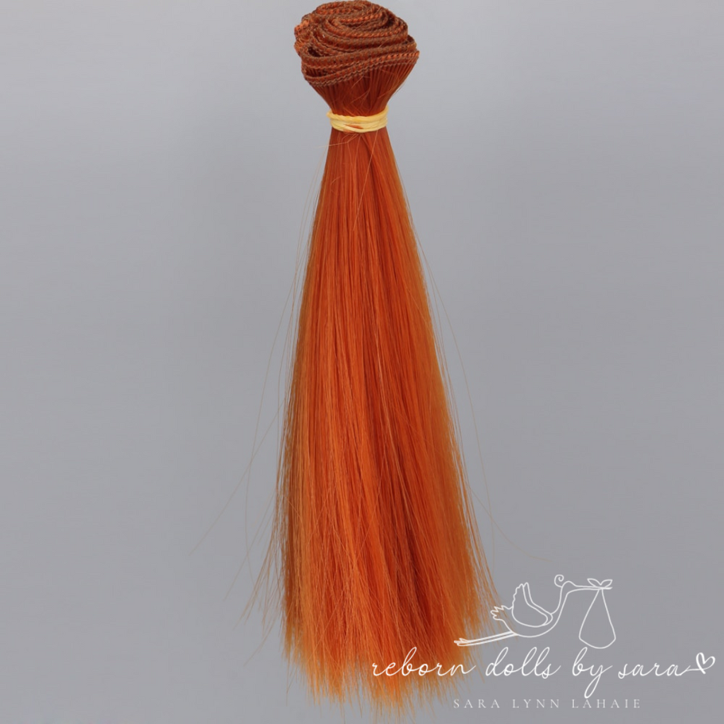 Copper red orange synthetic doll hair for alternative reborn dolls 15cm long.