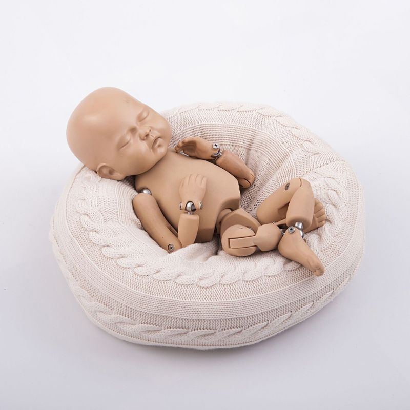 Shows reborn doll in Cream/white posing pillow for reborn dolls or newborn photography with knit cover.