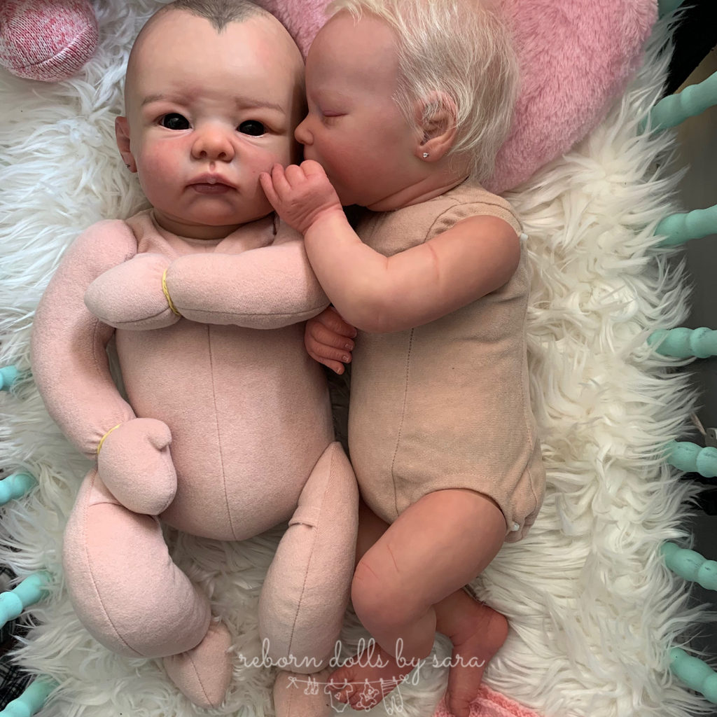 What is the difference between a cuddle baby and a reborn doll? On the left is cuddle baby Bethany by Linda Murray, right is realborn reborn Darren by Bountiful Baby, a regular vinyl reborn with limbs.