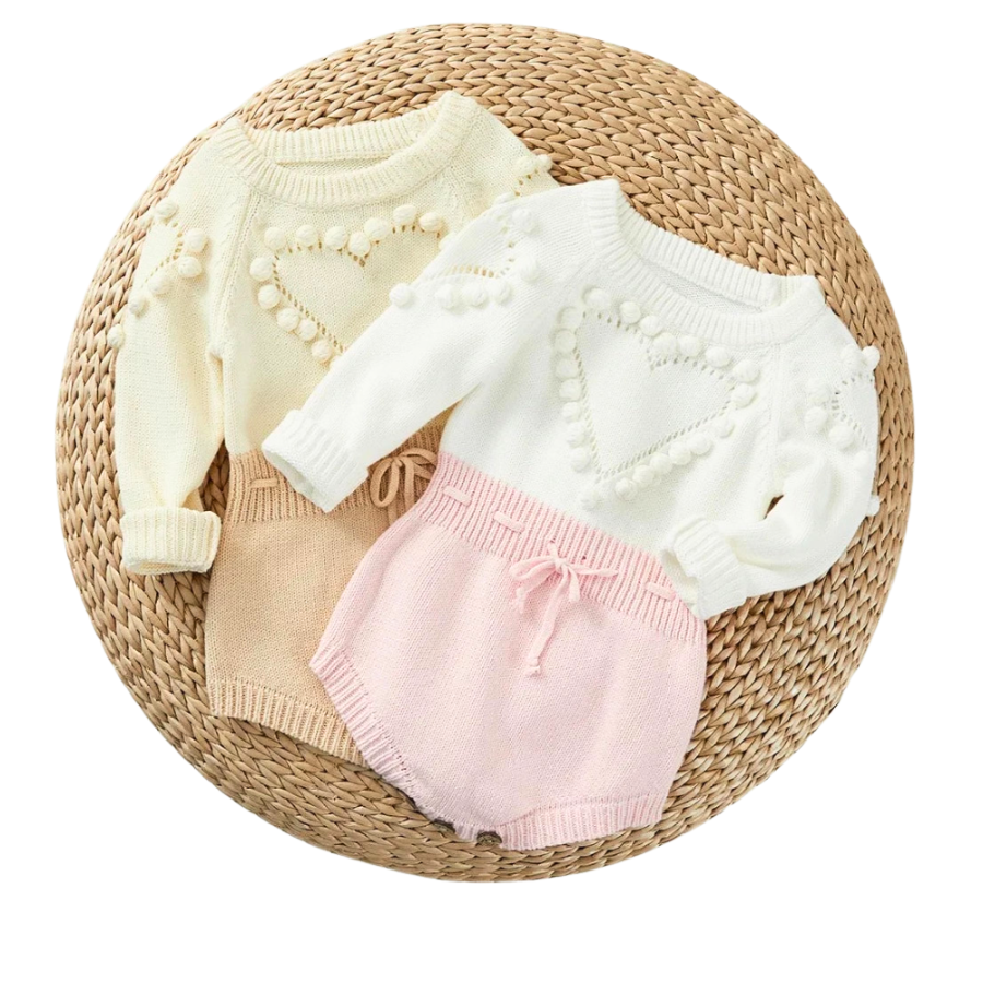 Knitted long sleeve baby romper onesie with pompom heart over chest for reborn dolls, newborns and Valentine's Day.