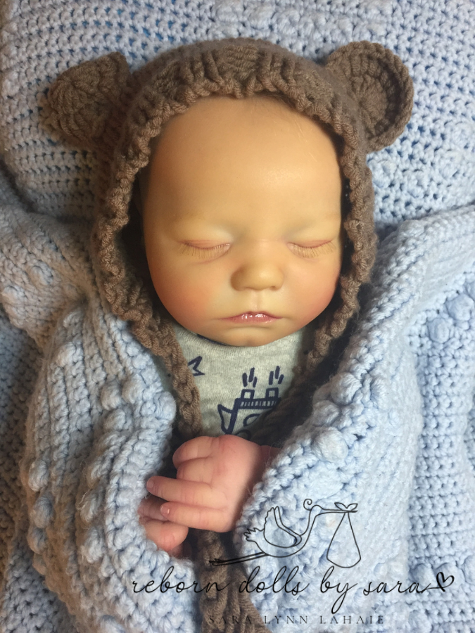 Reborn doll Realborn sleeping Zuri by Bountiful baby wearing the brown Lovey hand knitted newborn baby bear hat with matching teddy.