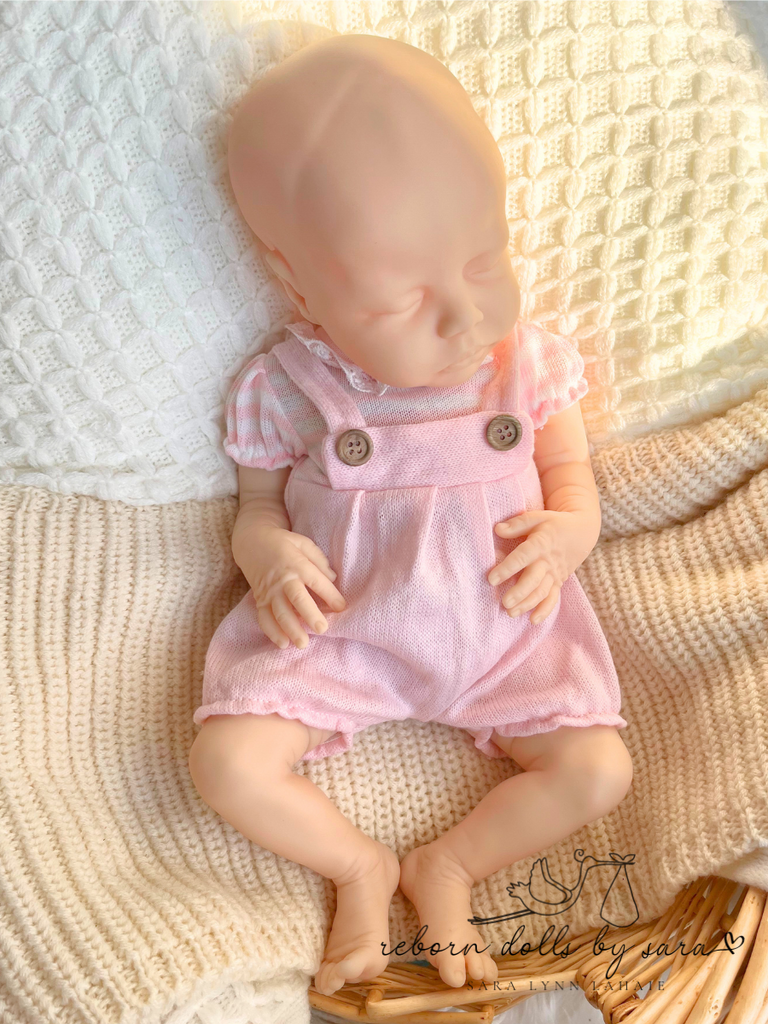 Reborn doll baby girl Deliah by Nikki Johnston wearing the Emily and Anna Spanish Baby Bubble Romper for Reborn Dolls.