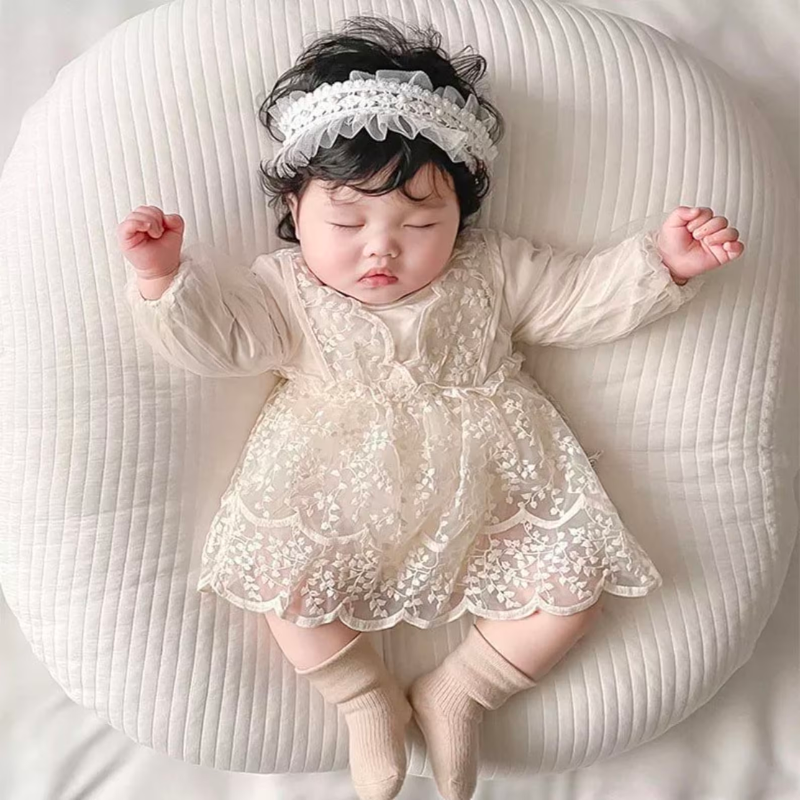 Newborn baby wearing Long-sleeve elegant lace dress with vine embroidery for reborn baby dolls.