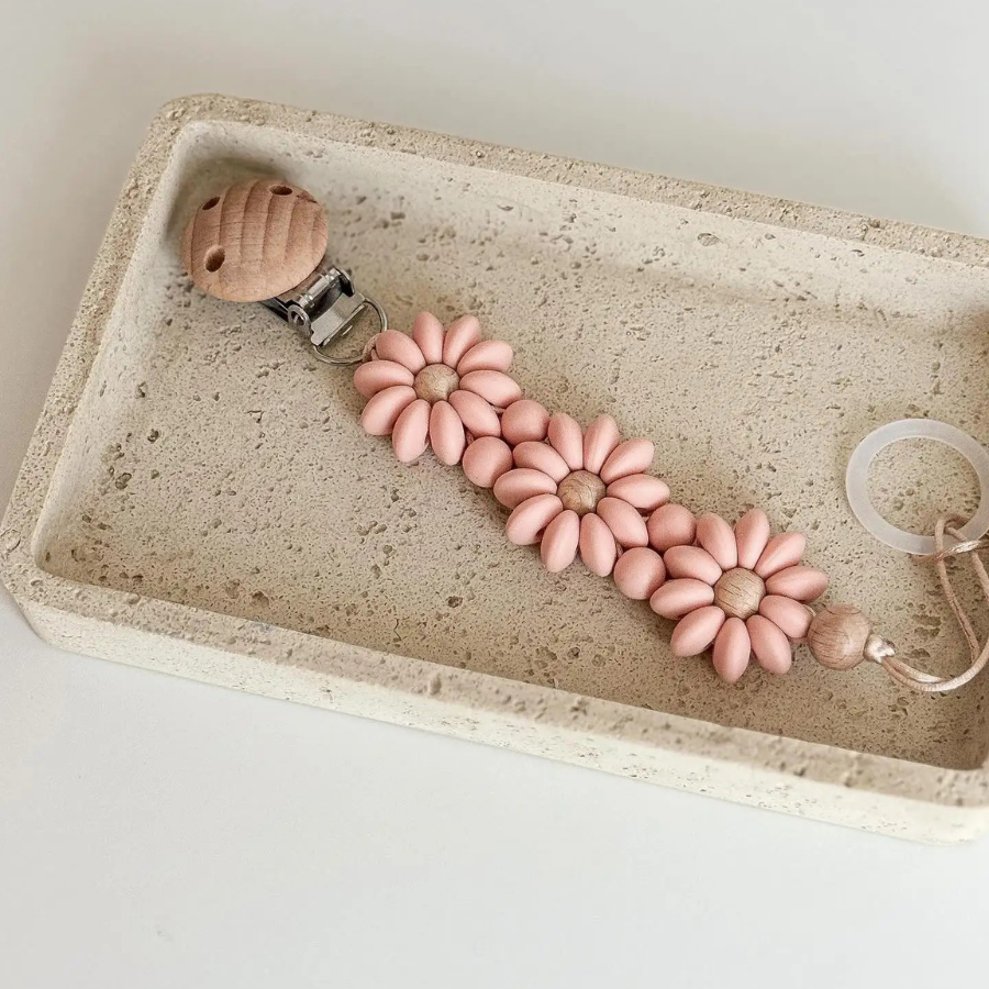 Pink Boho baby pacifier clip in the shape of a daisy flower. Made of silicone saucer beads on a wooden clip with wooden beads for reborn dolls.