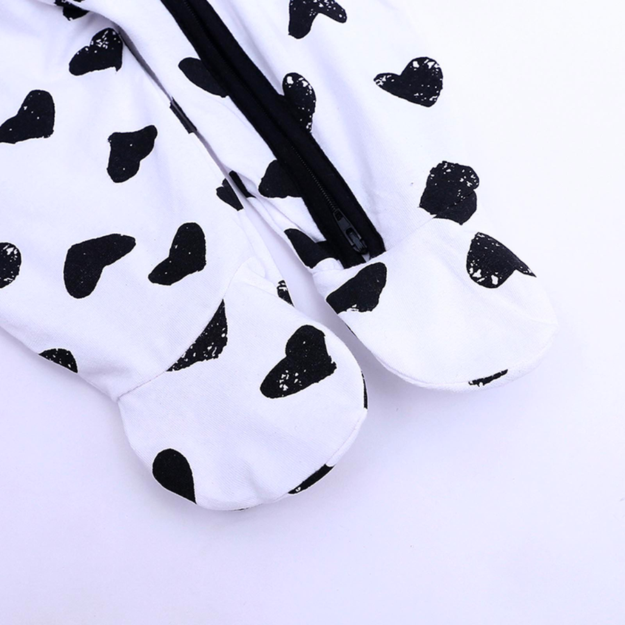 Black hearts on a white sleep n' play coverall zip-up romper with feeties for baby girls, reborn dolls, and cuddle babies.