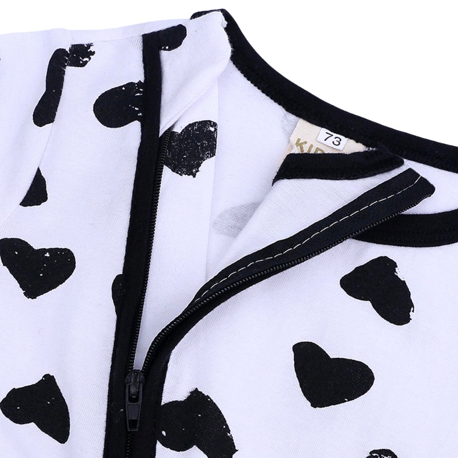 Black hearts on a white sleep n' play coverall zip-up romper with feeties for baby girls, reborn dolls, and cuddle babies.