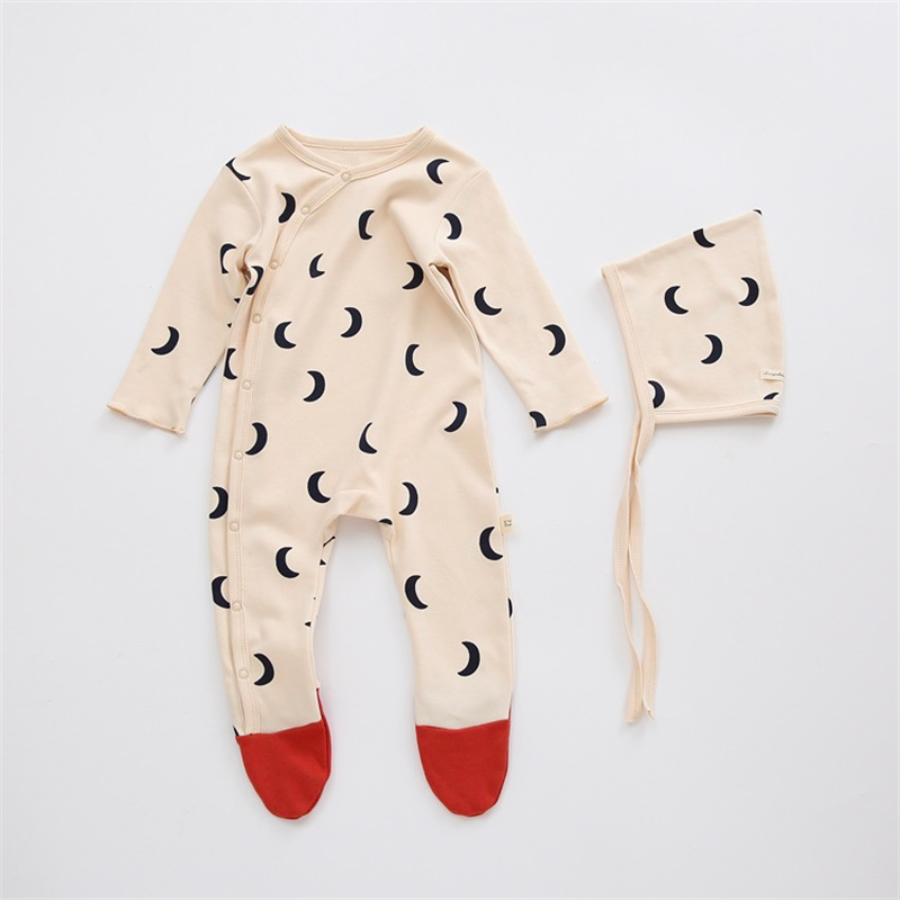 Off-white cream coloured long-sleeve button-up romper with ginger red toe tips and black moon crescents all over it. Comes with a matching pixie bonnet hat with a drawstring for babies and reborn dolls.