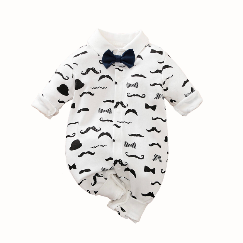 White long-sleeve button-up collared romper with black moustaches all over it and a navy blue bow tie for newborn babies and reborn dolls. 