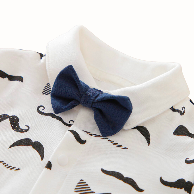 White long-sleeve button-up collared romper with black moustaches all over it and a navy blue bow tie for newborn babies and reborn dolls. 