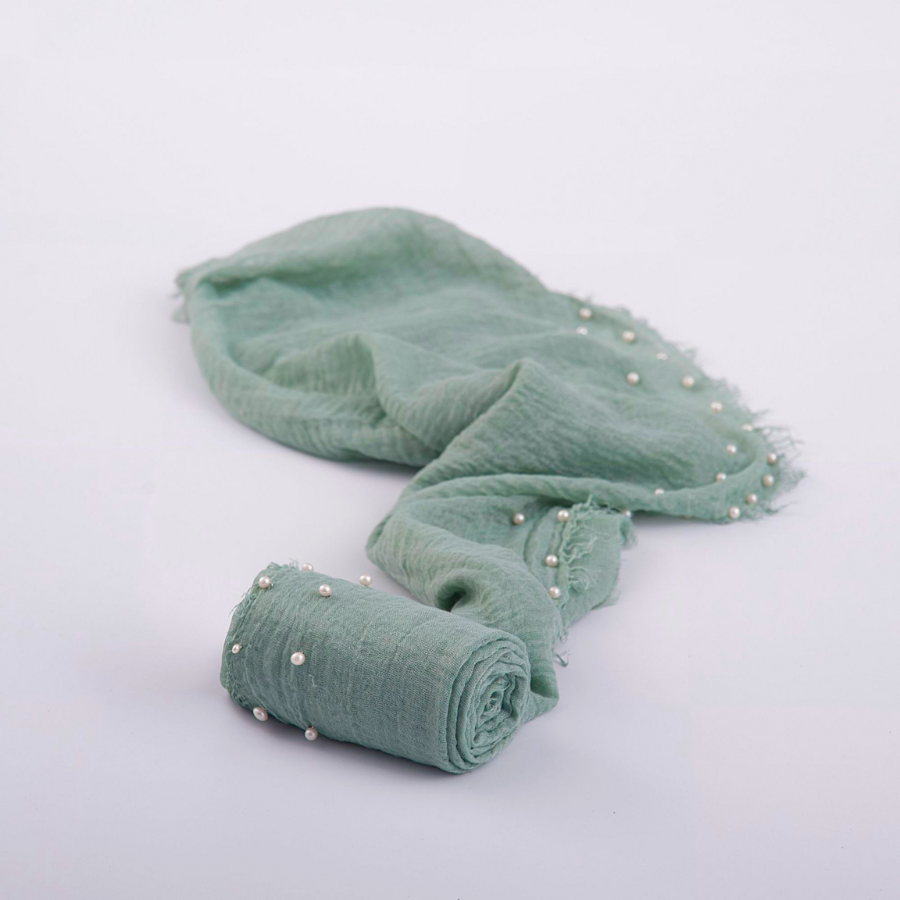 Sage green pearl raw edge muslin wrap swaddle for reborn dolls and newborn photography.