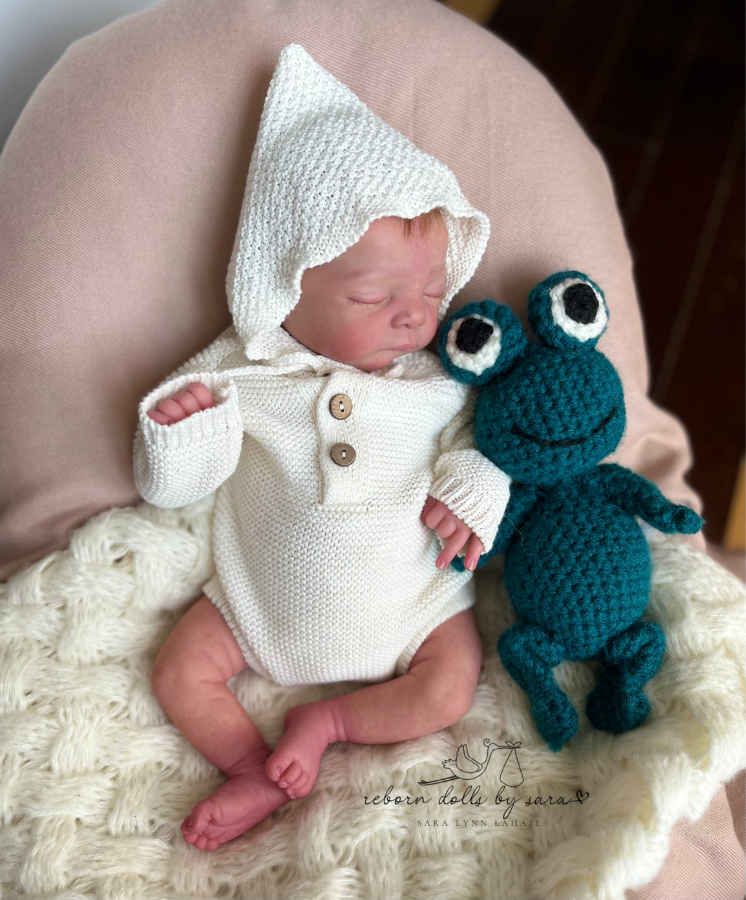 Reborn baby boy Mick by Adrie Stoete wearing the crochet knitted newborn baby longsleeve bodysuit onesie with pixie bonnet for reborn dolls and babies. Baby shower gift. Expectant mom mother to be gift. Crochet newborn baby bodysuit onesie pixie bonnet. Reborn clothing. Reborn Clothes.