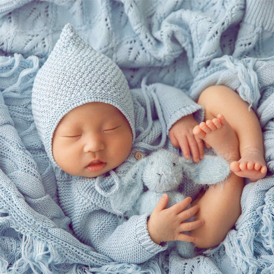 Newborn baby boy wearing the light blue crochet knitted newborn baby longsleeve bodysuit onesie with pixie bonnet for reborn dolls and babies. Baby shower gift. Expectant mom mother to be gift. Crochet newborn baby bodysuit onesie pixie bonnet. Reborn clothing. Reborn Clothes.