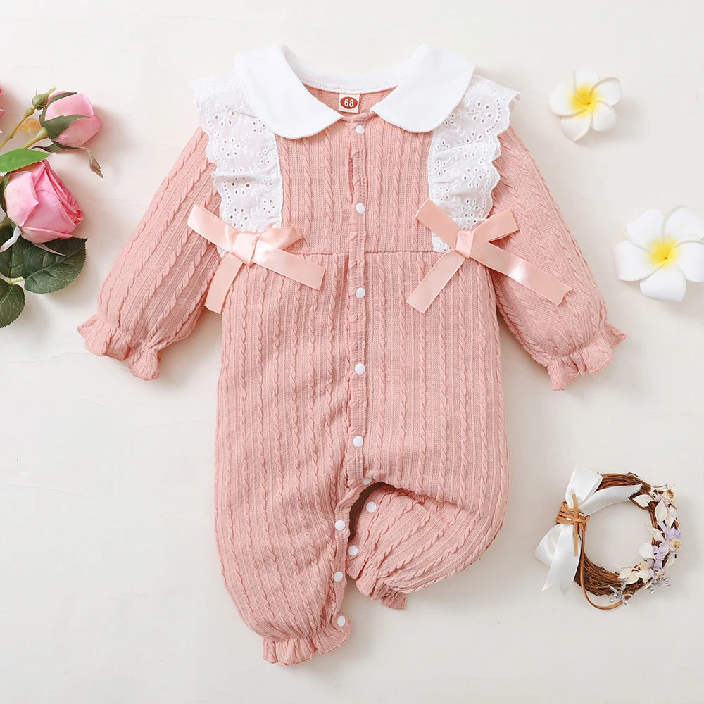 Pink baby girl longsleeve romper with lace chest frills, peter pan collar, snap buttons and frilly ankles and wrists.