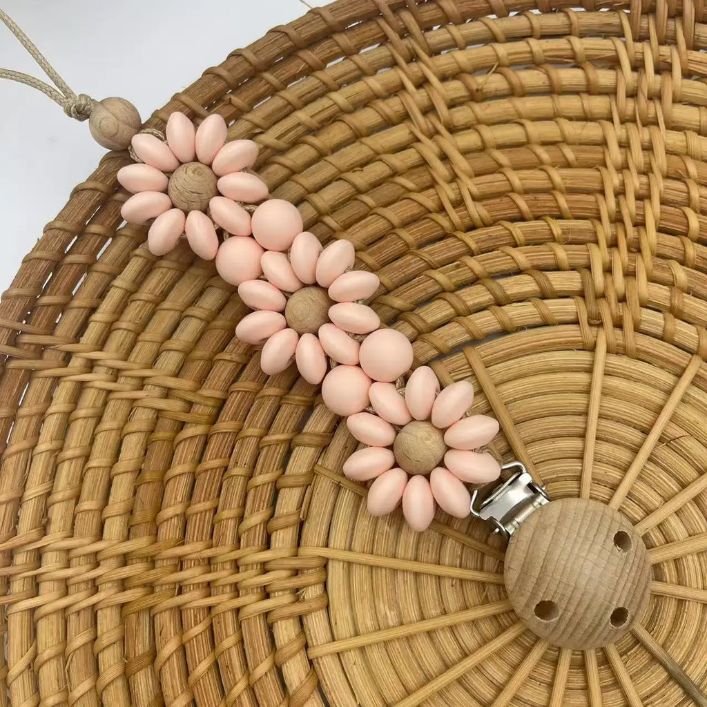 Peach Boho baby pacifier clip in the shape of a daisy flower. Made of silicone saucer beads on a wooden clip with wooden beads for reborn dolls.