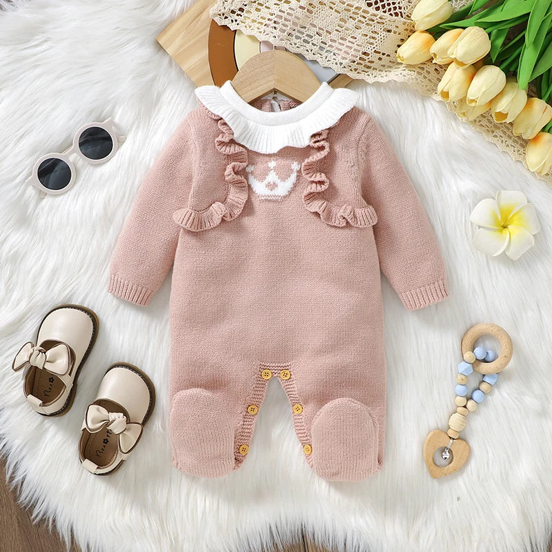 Pink footed cable knit romper for reborn dolls with white Peter Pan collar and white princess crown on the chest with a pink heart in the centre.