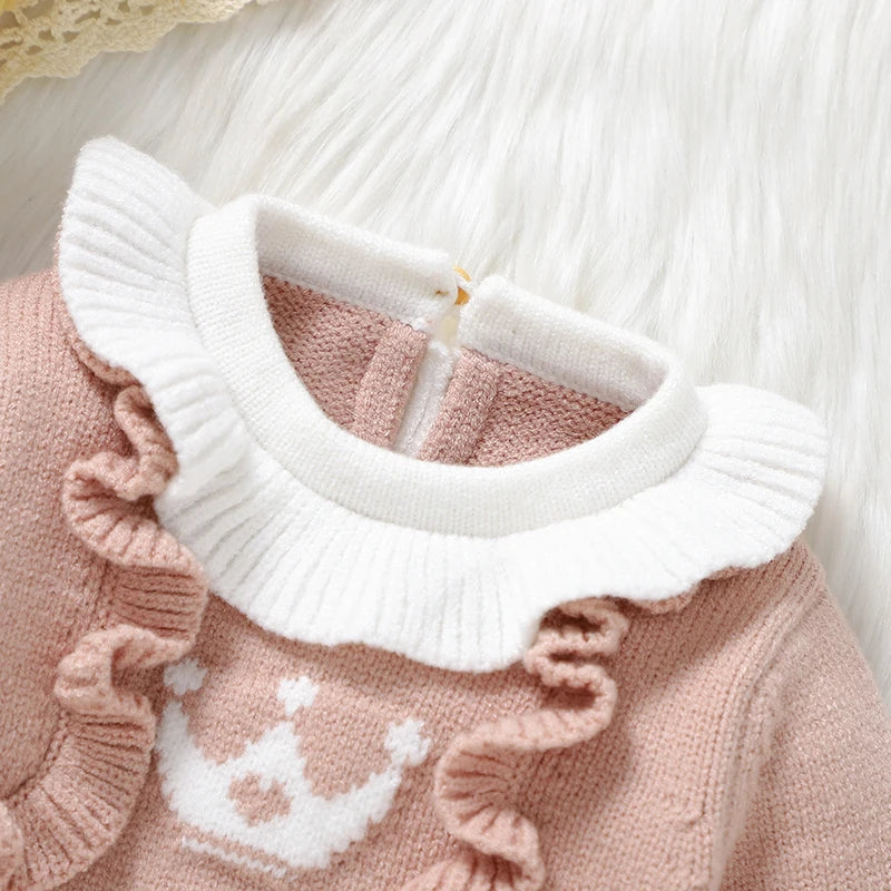 Pink footed cable knit romper for reborn dolls with white Peter Pan collar and white princess crown on the chest with a pink heart in the centre.