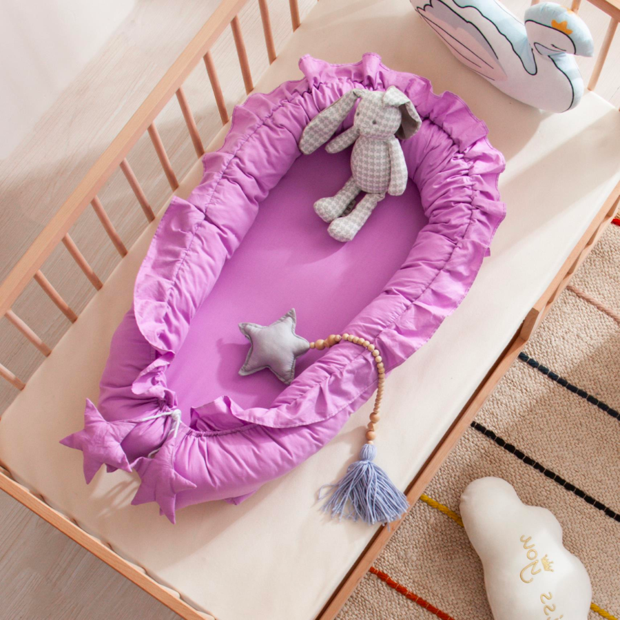 Purple shooting star boho baby nest with ruffles for newborn babies and reborn doll displays.