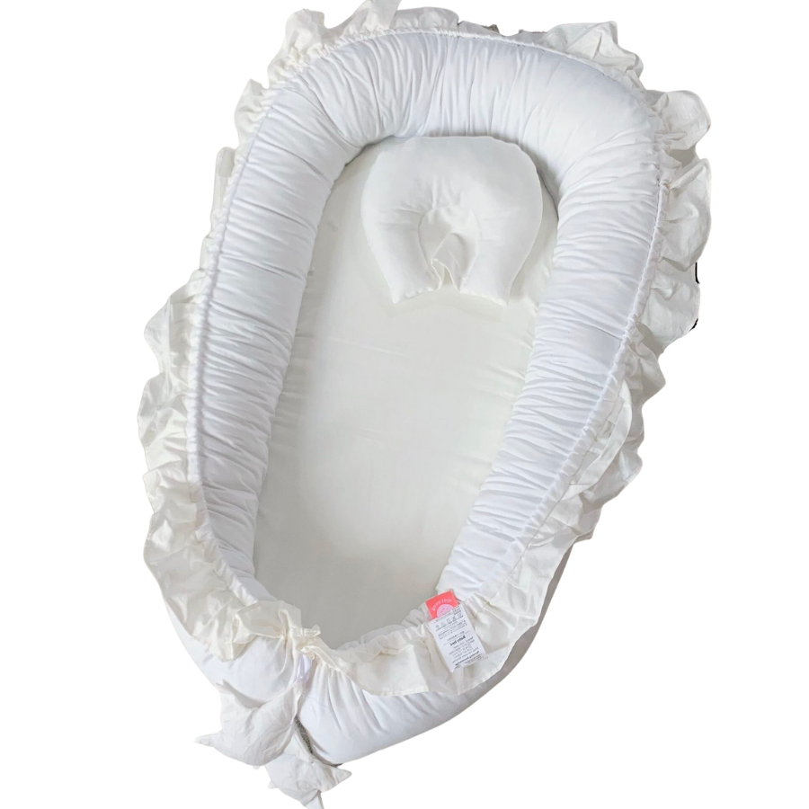 Ivory white shooting star boho baby nest with ruffles for newborn babies and reborn doll displays.