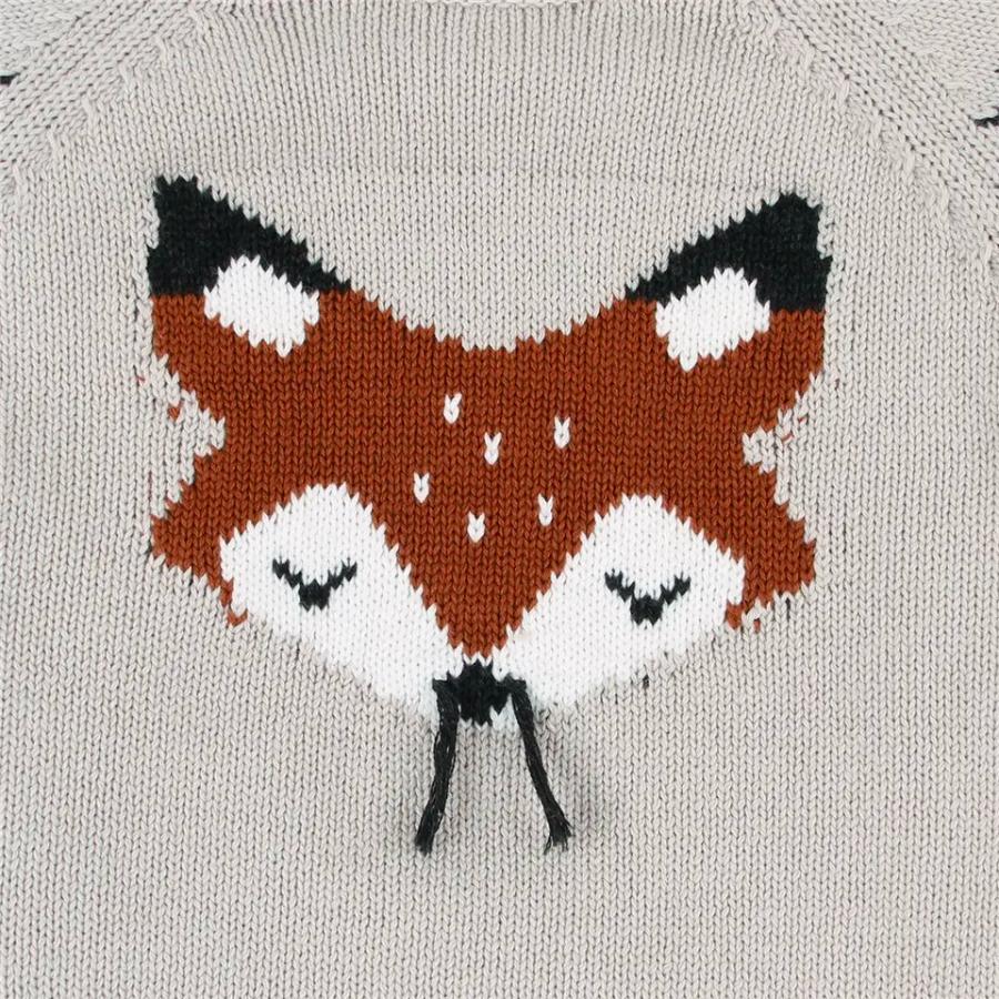 Close-up of the red orange sleeping fox on a grey knitted long-sleeve sweater onesie for reborn baby dolls.
