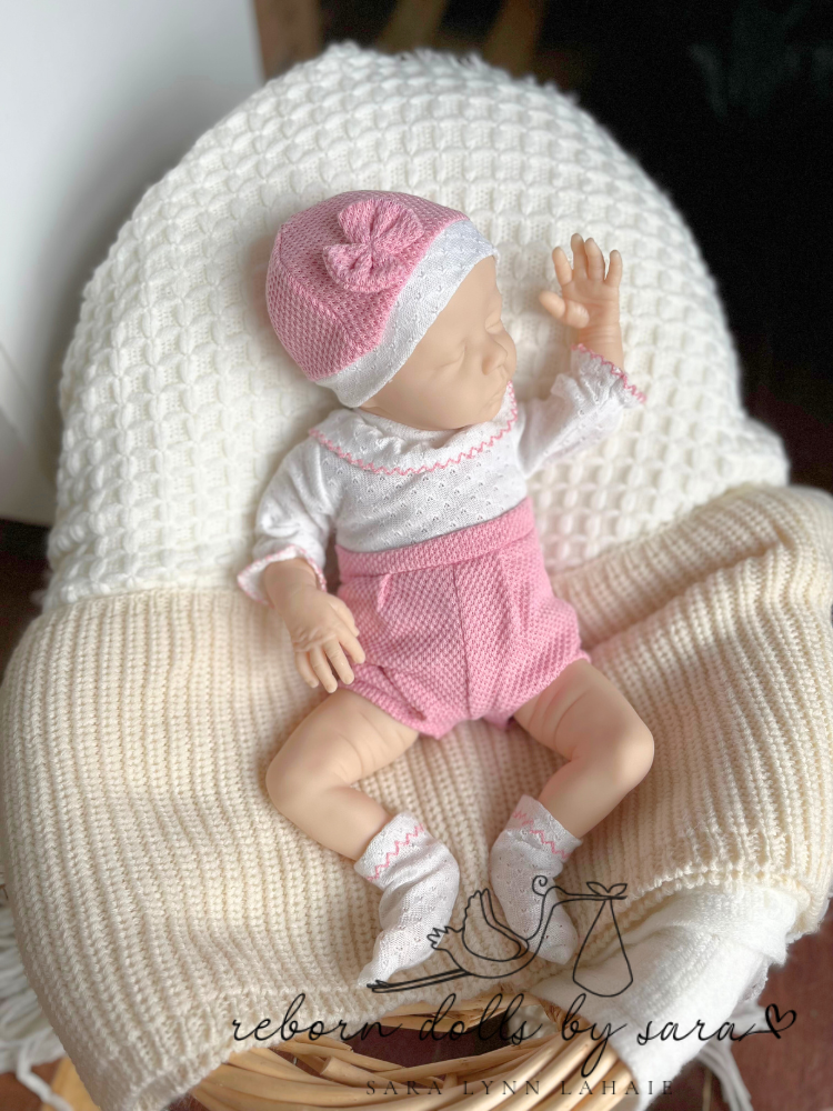 Preemie reborn baby doll 17" Delilah by Nikki Johnston wearing a Spanish baby bubble romper for mini reborn dolls.