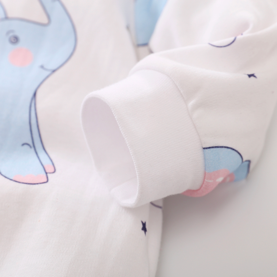 Close-up of the wrist cuff on the sleeve of a white long-sleeve baby romper with blue elephants, rainbows, flamingos, stars and hearts on it for reborn baby dolls.