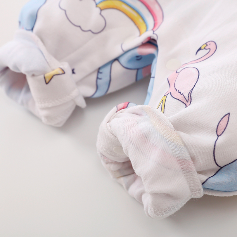 Close-up of the crotch and ankles rolled up on the pant leg of a white long-sleeve baby romper with blue elephants, rainbows, flamingos, stars and hearts on it for reborn baby dolls.