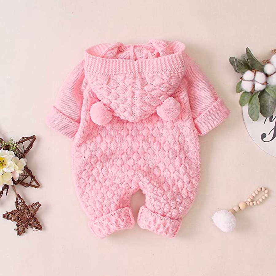 Backside of a pink knitted long-sleeve button-down teddy bear romper with hood and two pompom bear ears for reborn baby dolls.