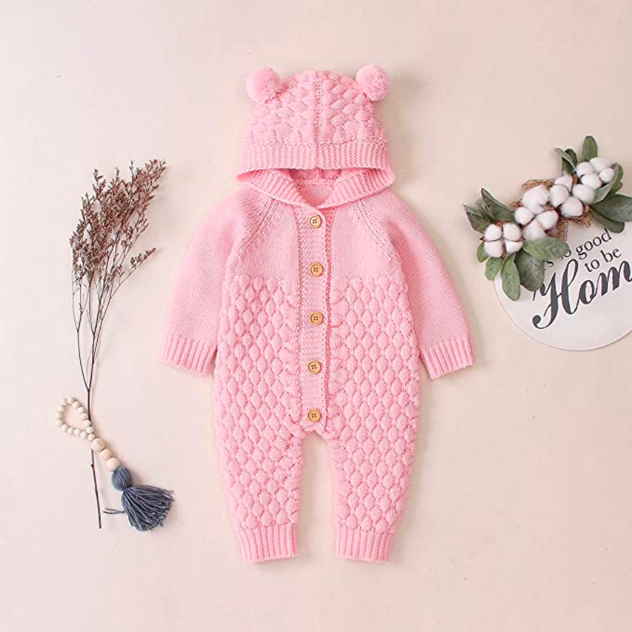 Pink knitted long-sleeve button-down teddy bear romper with hood and two pompoms for reborn baby dolls.