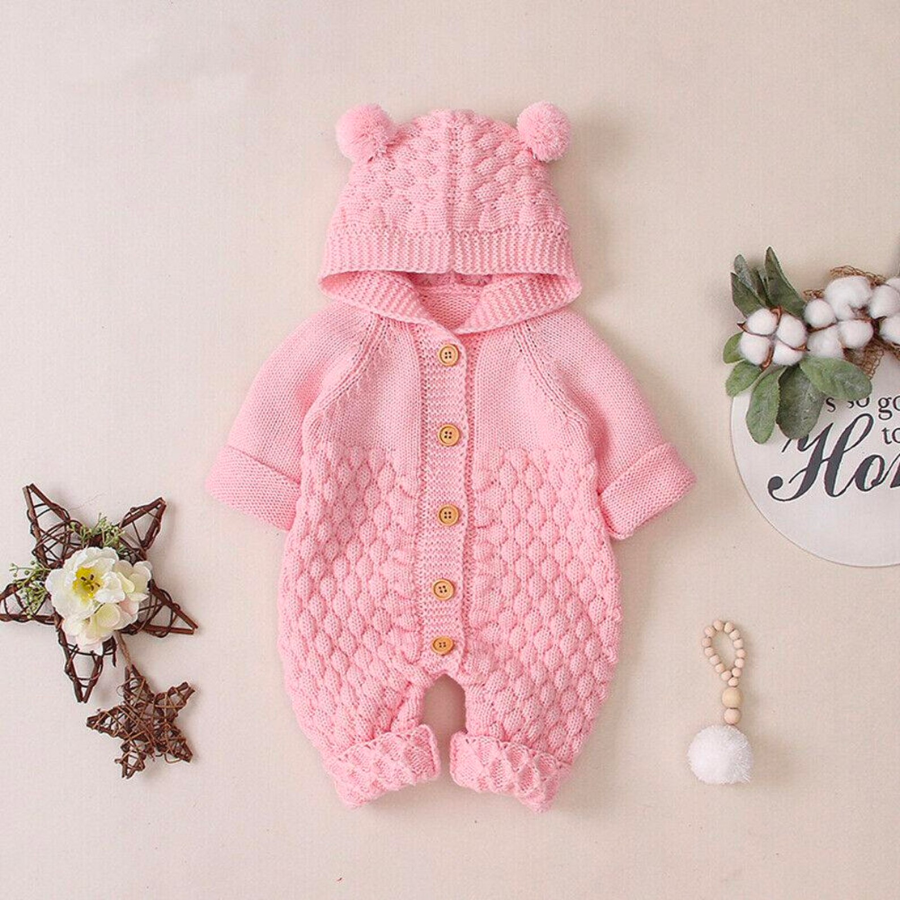 Pink knitted long-sleeve button-down teddy bear romper with hood and two pompoms for reborn baby dolls.