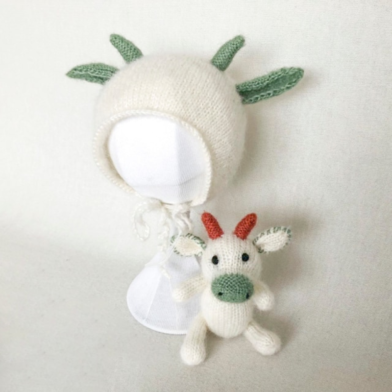 Knitted green and white cow hat for reborn and newborn photography with matching stuffie.