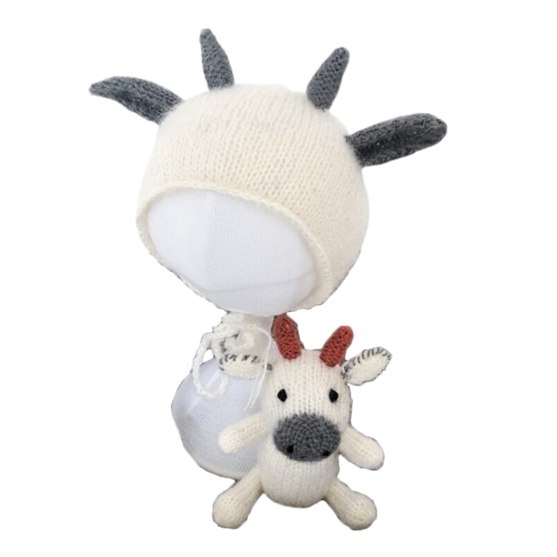 Grey and white Knitted cow reborn and newborn photography hat with matching stuffie.