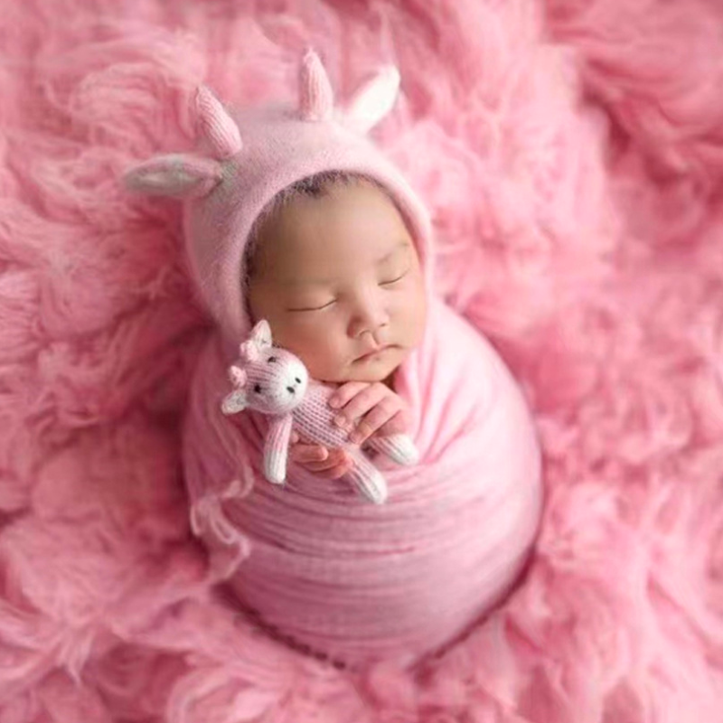 Newborn baby girl wearing pink and white knitted crochet cow hat and matching cow stuffie for reborn dolls, newborn photography, reborn photoshoots, and cuddle babies.
