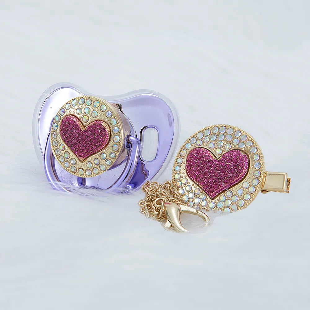 Metallic purple Bling luxury rhinestone pacifiers and matching gold chain clips for reborn dolls and newborn babies.
