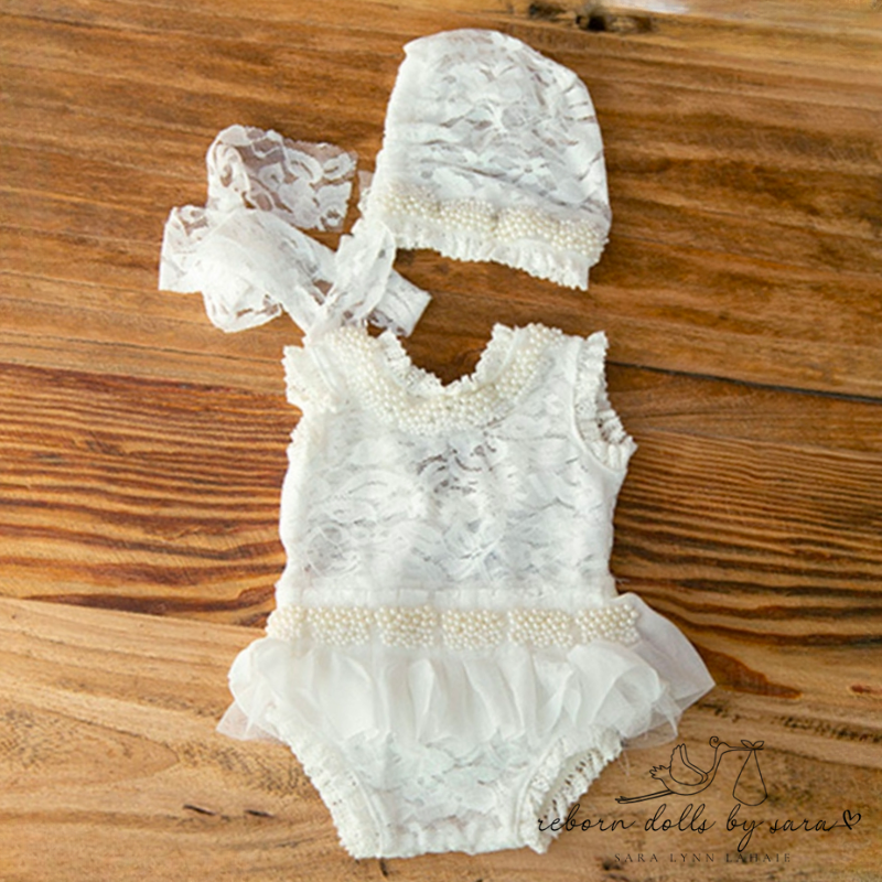 Handmade lace and pearl onesie with tutu and matching vintage bonnet for newborns and reborn baby girls.