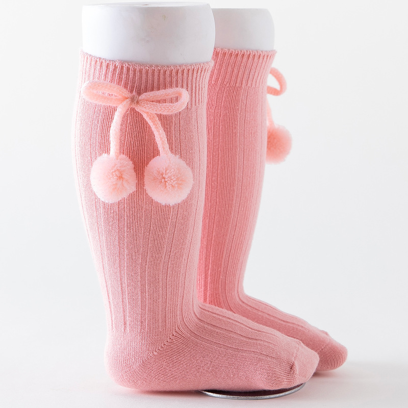 Pink knee-high Spanish baby socks with pompoms for reborn baby dolls boys and girls.