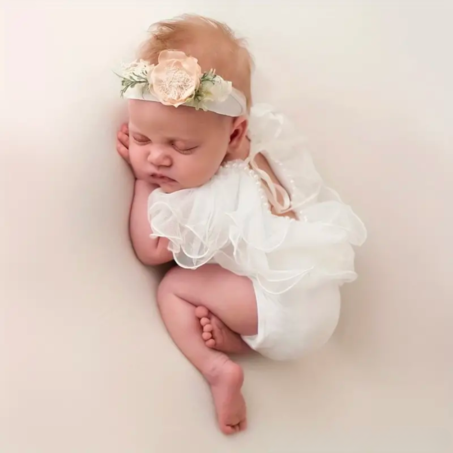 White Newborn baby girl photography outfit for reborn dolls and newborn photography. Has pearls, lace, and ruffles.