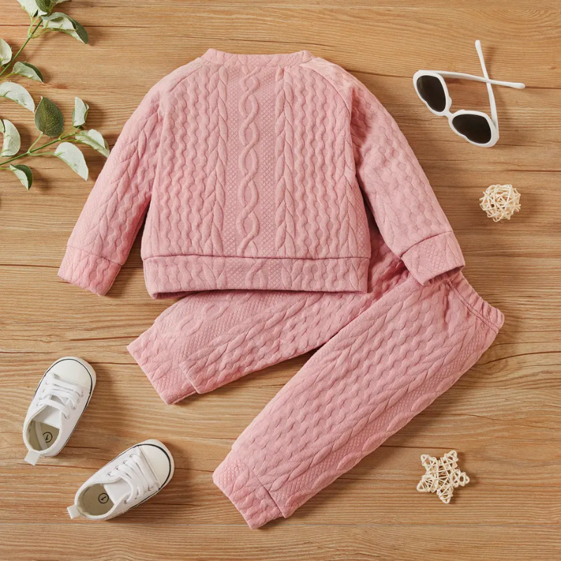Pink cable knitted pullover two piece outfit with matching pants for reborn dolls or cuddle babies or newborn babies. Hand knit gender neutral newborn baby outfit.