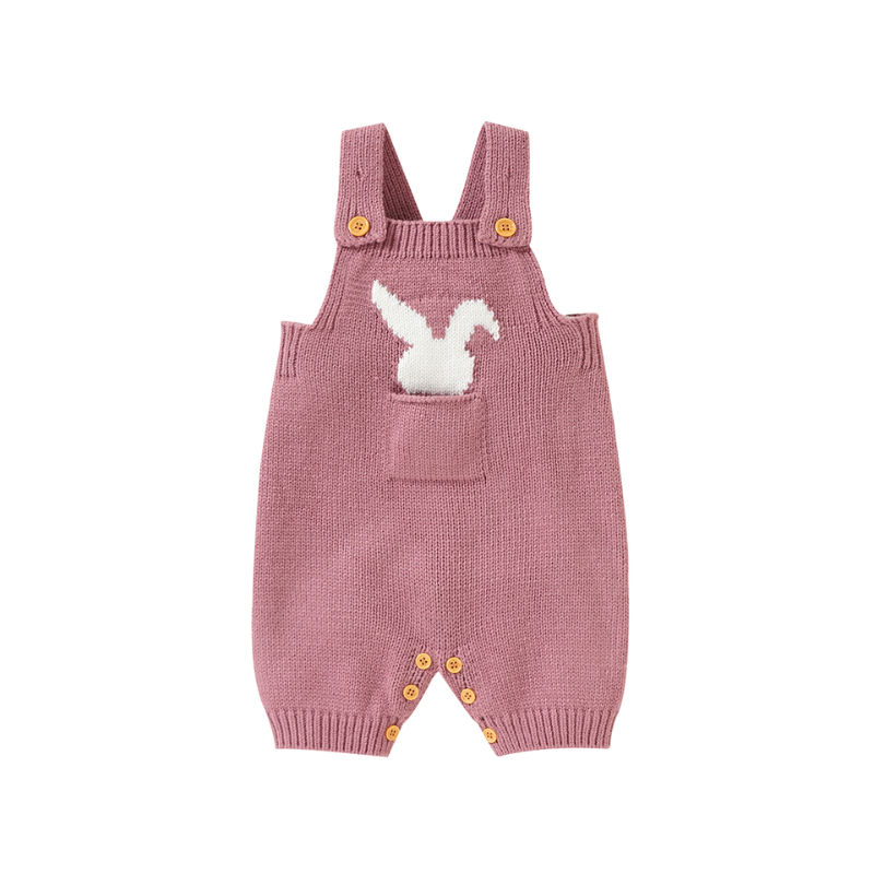 Pink knitted overall shorts with front pockets on the chest and a little white silhouette of a bunny sticking out of the pocket for newborn babies and reborn dolls.