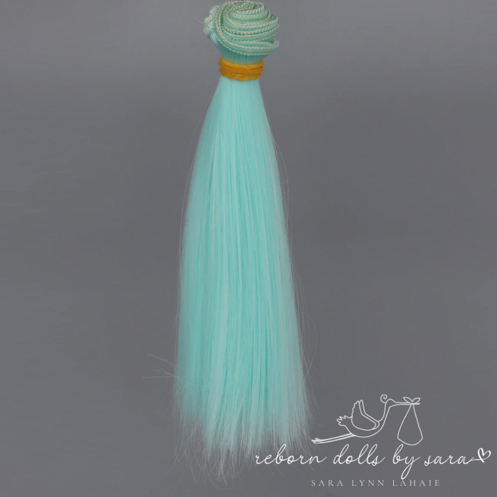 Light aqua blue synthetic doll hair for alternative reborn dolls 15cm long.