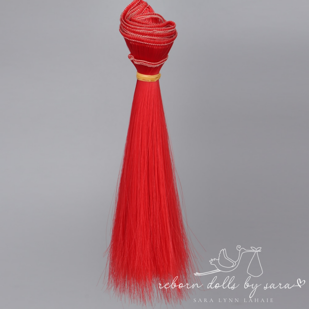 Fire engine red aka scarlet red synthetic doll hair for alternative reborn dolls 15cm long.