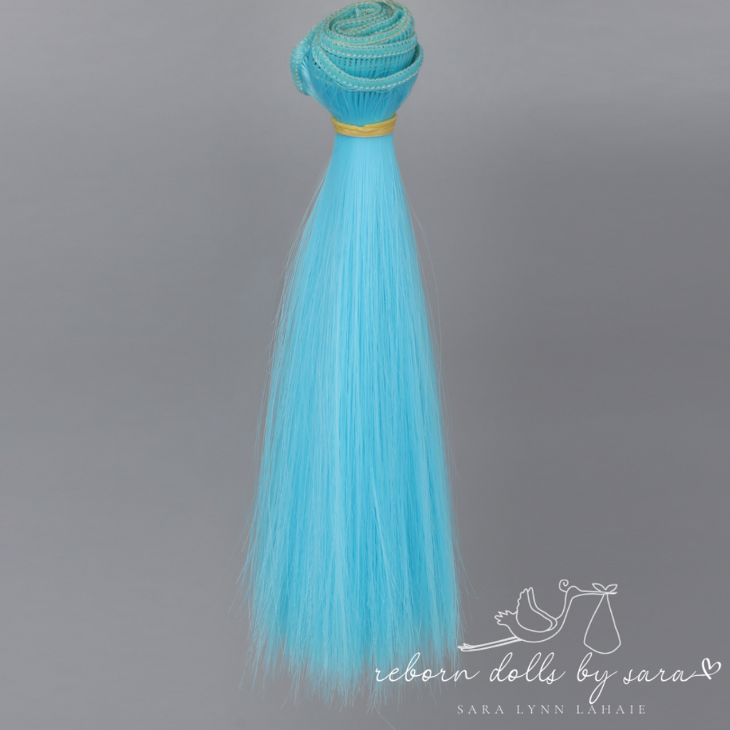 Light cyan blue synthetic doll hair for alternative reborn dolls 15cm long.