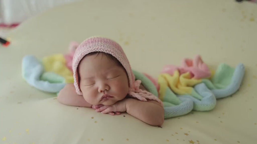The bundlejoy pastel rainbow coloured hand knitted and crocheted newborn baby photography wrap and bonnet for babies and reborn dolls. Video showing product.