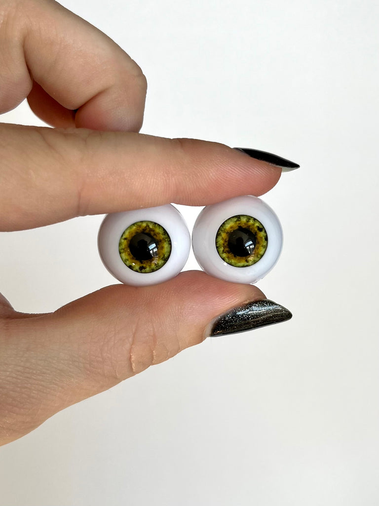 20mm green half round acrylic eyes with brown flecks around the large pupil for reborn dolls.