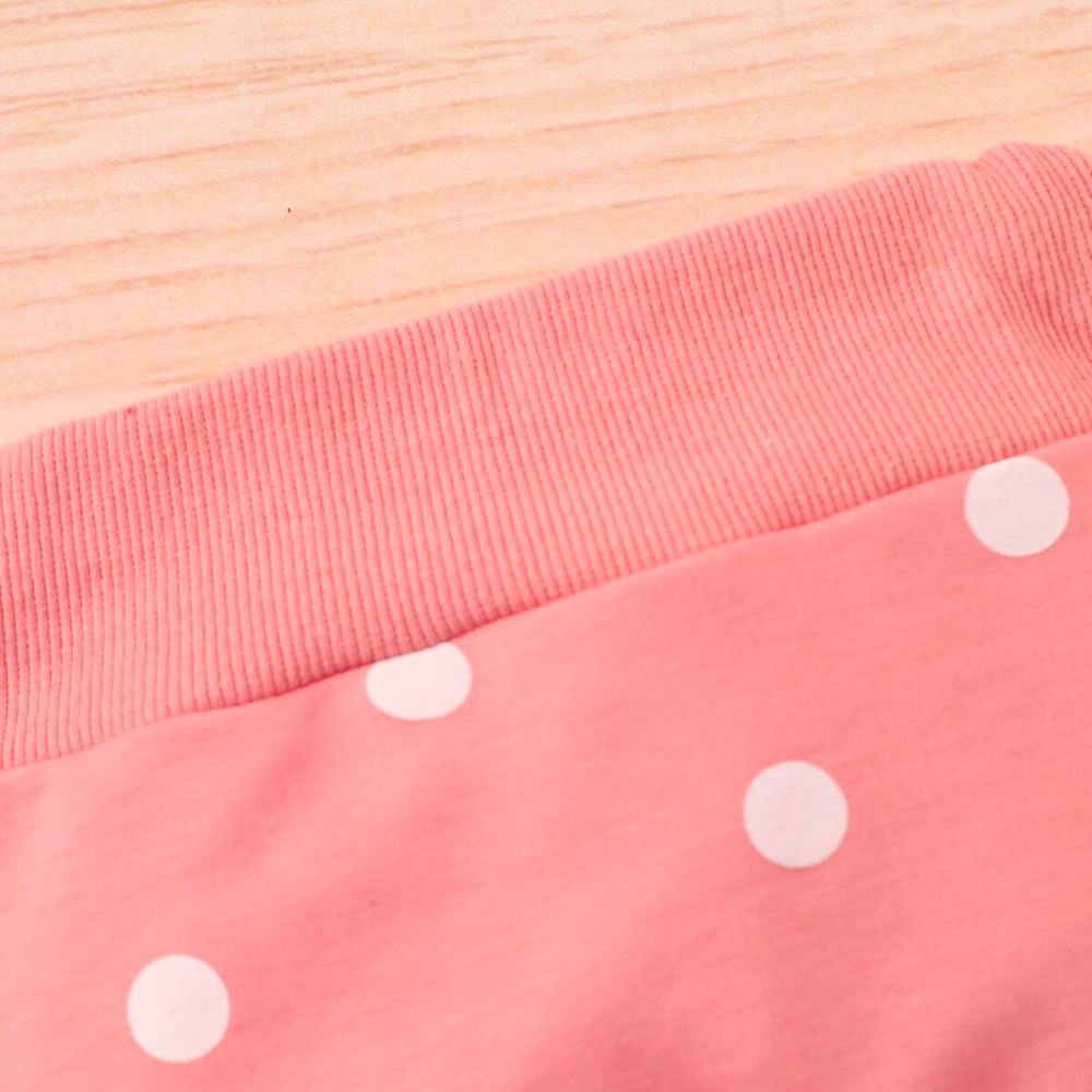 Close-up of the waist band on a Pink jogging suit with white polka dots for newborn babies and reborn baby dolls.