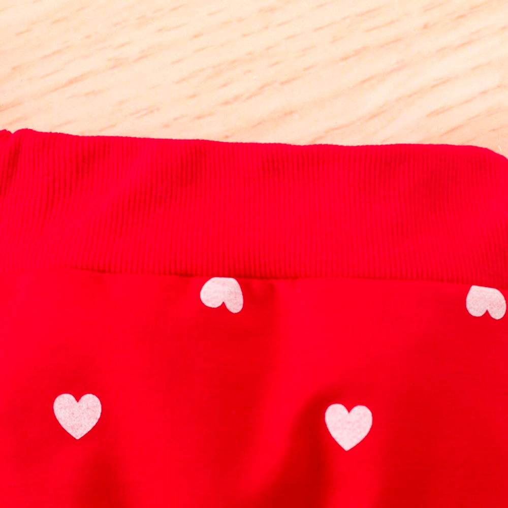 Close up of the elastic waistband on a Red jogging suit with white hearts for newborn babies and reborn baby dolls.