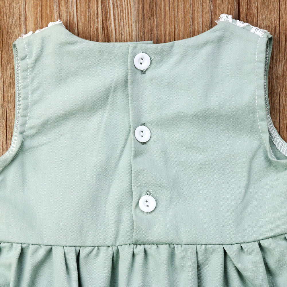 close-up of back buttons on mint green Spanish baby clothing bubble romper for reborns and babies: reborn doll clothing