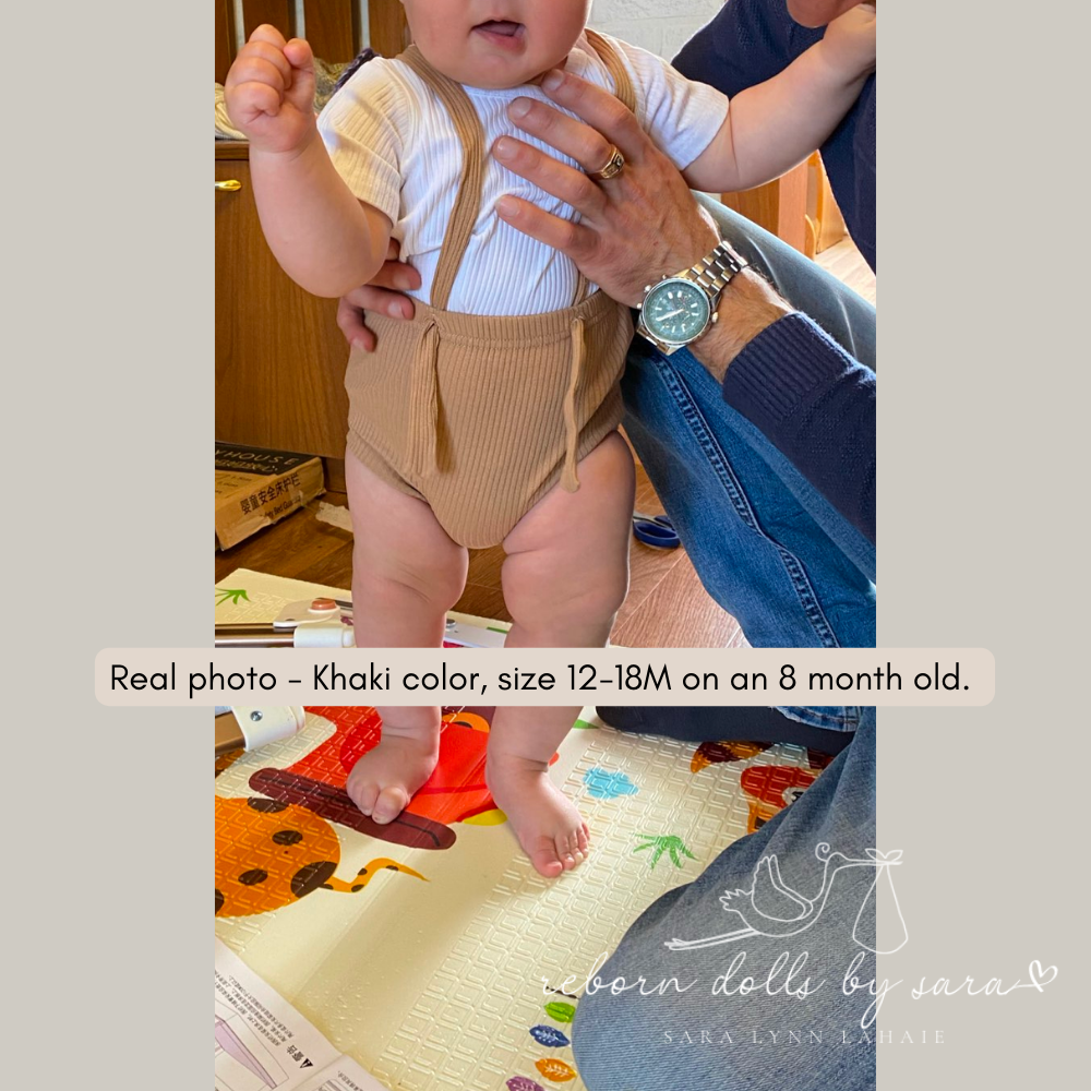 Real 8 month old baby wearing a pair of size 12-18M khaki ribbed boho baby bloomers with suspenders for reborn baby dolls.
