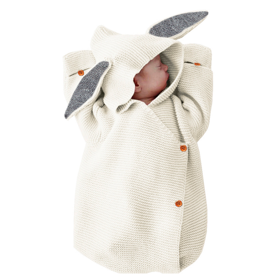 Newborn baby in a white knitted bunny rabbit sleep sacks sleeping bags for newborn babies and reborn dolls.