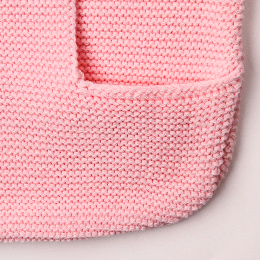 The bottom and envelope of a pink knitted bunny rabbit sleep sacks sleeping bags for newborn babies and reborn dolls.